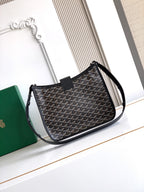 Black patterned shoulder bag with structured body, flap, and top handle