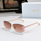 Dior sunglasses with rose gold frame, brown lenses, pink floral temple accents.