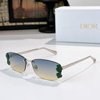Dior sunglasses with silver frame, blue tinted lenses, green floral temple accents.