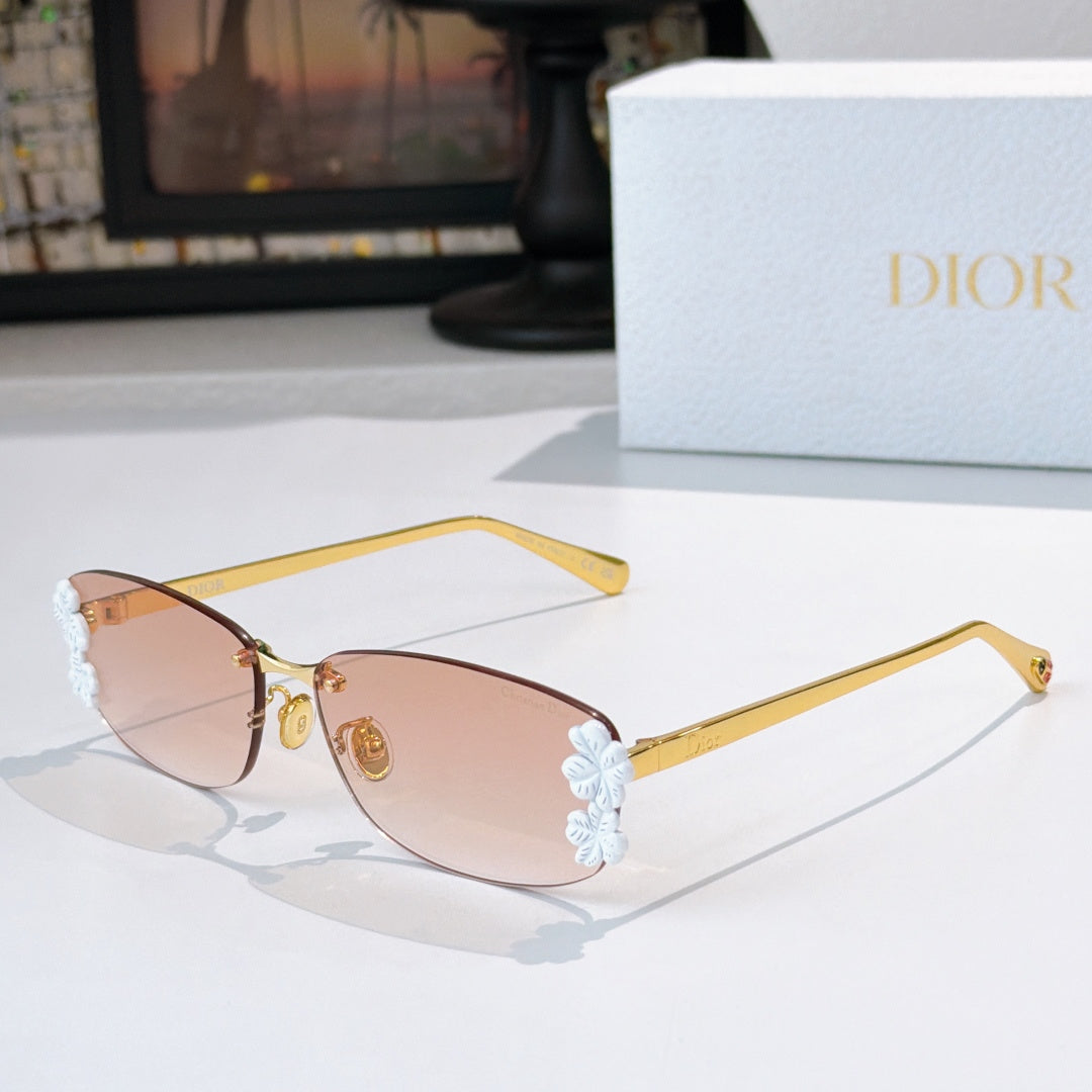Dior sunglasses with gold frame, pink lenses, white floral temple details.