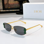 Dior sunglasses with gold frame, dark lenses, green floral temple details.