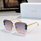 Dior sunglasses with gold frame and purple gradient lenses, green floral temple accents.