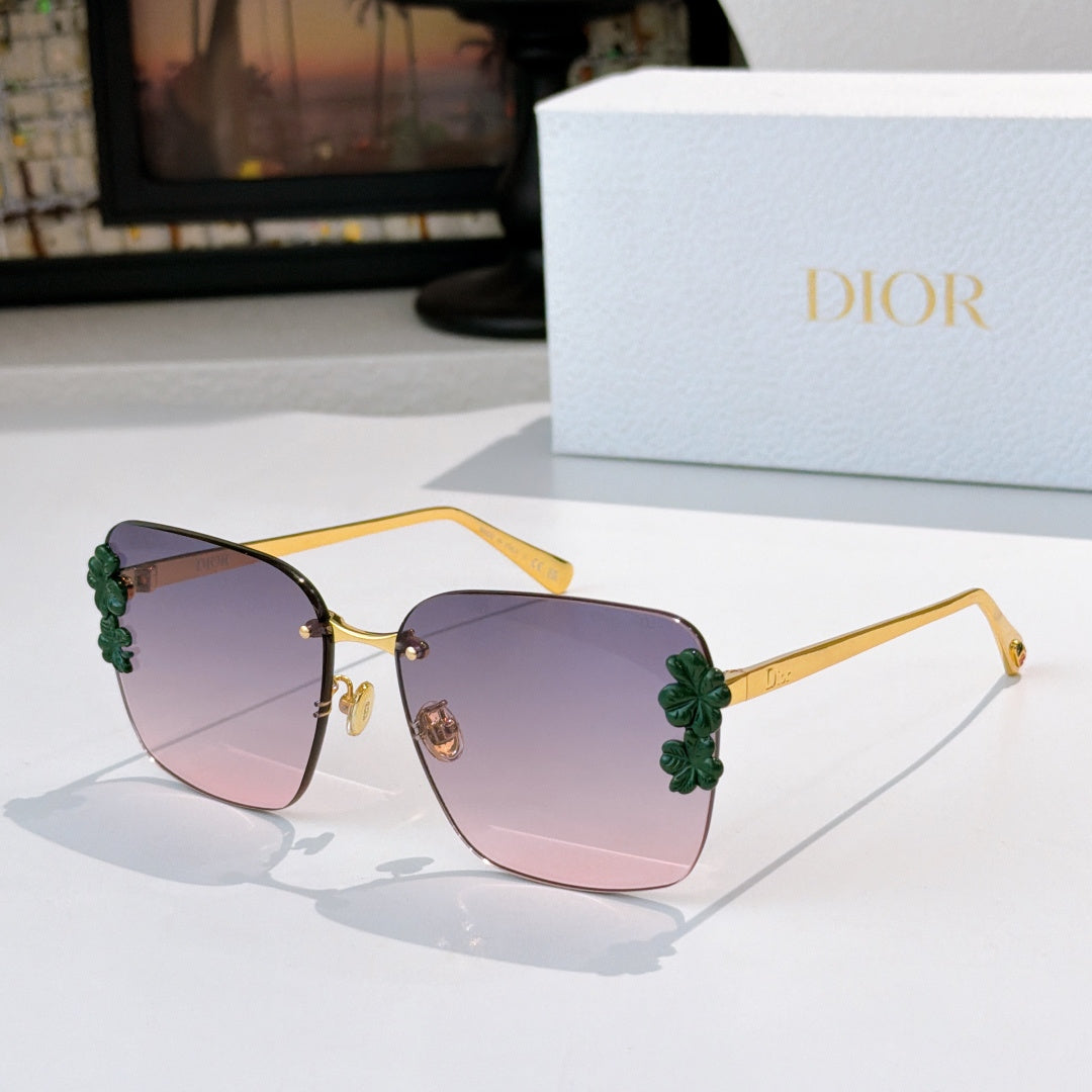 Dior sunglasses with gold frame and purple gradient lenses, green floral temple accents.
