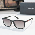 Prada black sunglasses with gradient dark lenses and curved full-frame design