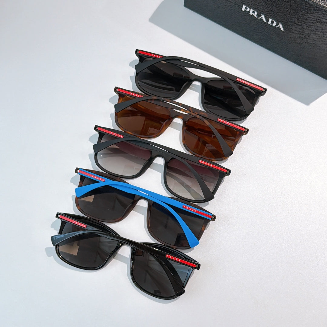 Prada sunglasses assortment with black, brown, and blue frames, stacked for display