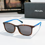 Prada tortoiseshell sunglasses with blue temple accents and gray-brown lenses
