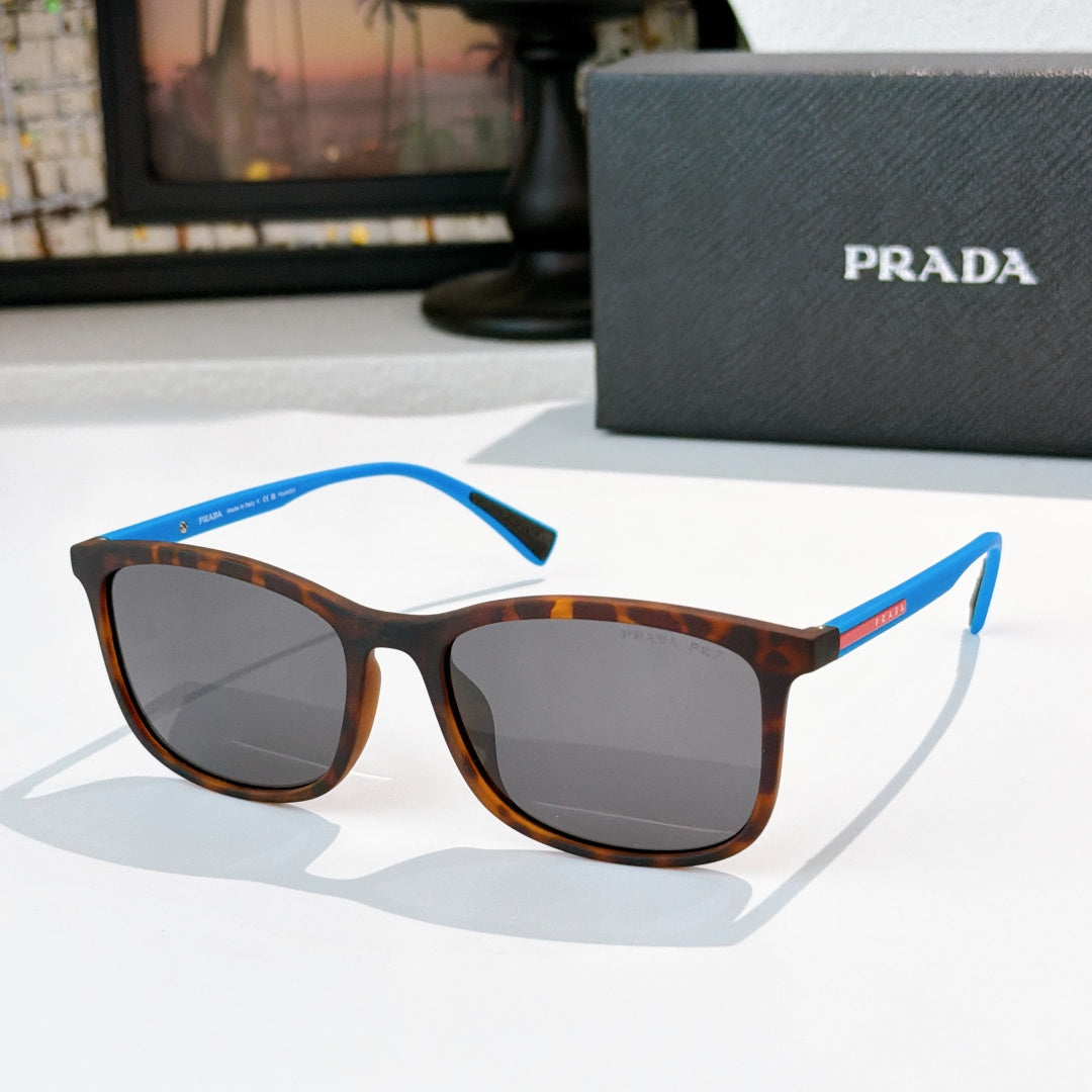 Prada tortoiseshell sunglasses with blue temple accents and gray-brown lenses