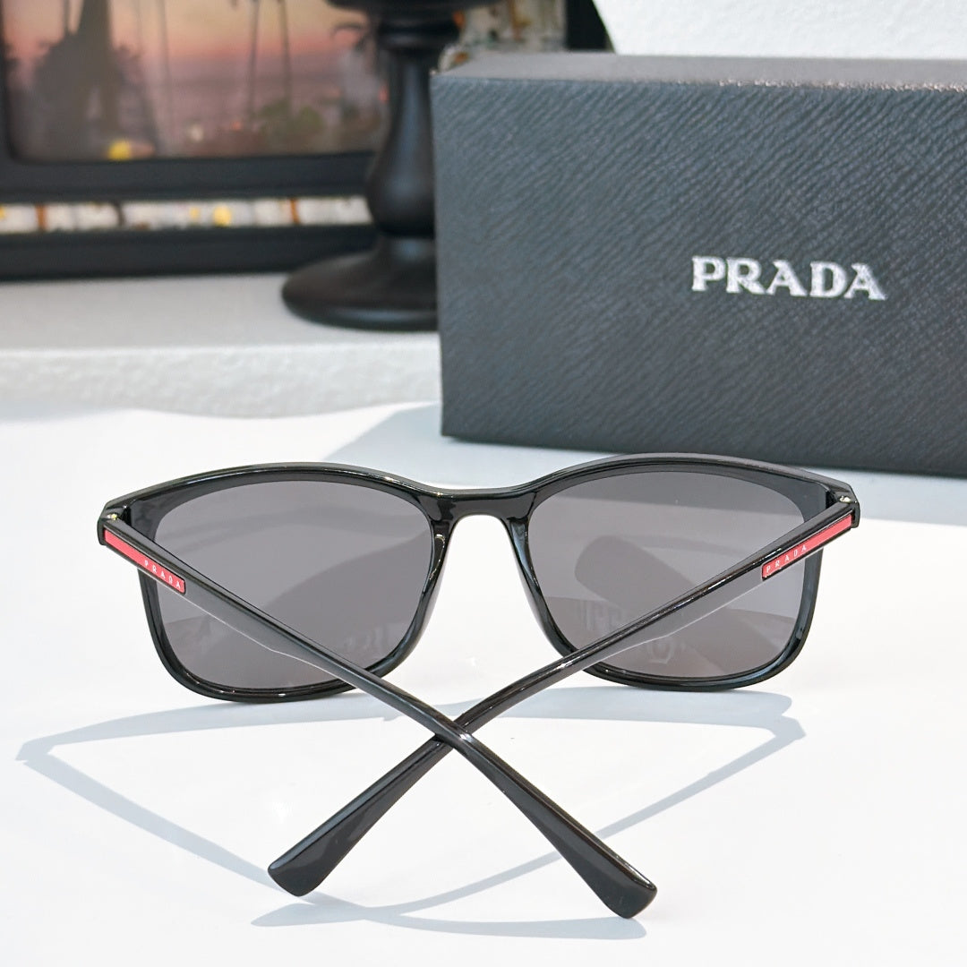 Prada black sunglasses front view with mirrored dark lenses and sporty frame