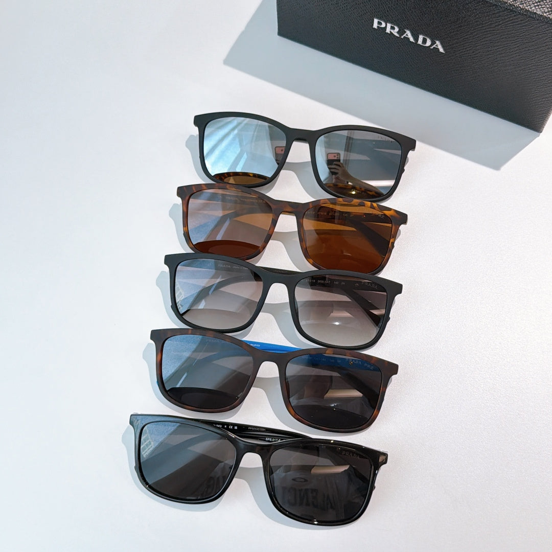 Prada sunglasses assortment with blue, tortoiseshell, and black frames on display