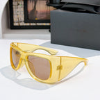 YSL sunglasses with yellow-gold frame and neutral tinted lenses
