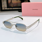 Sunglasses with silver frame, light blue lenses, and green temple tips.