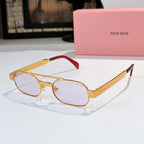 Sunglasses with gold frame, clear lenses, and red temple accents.