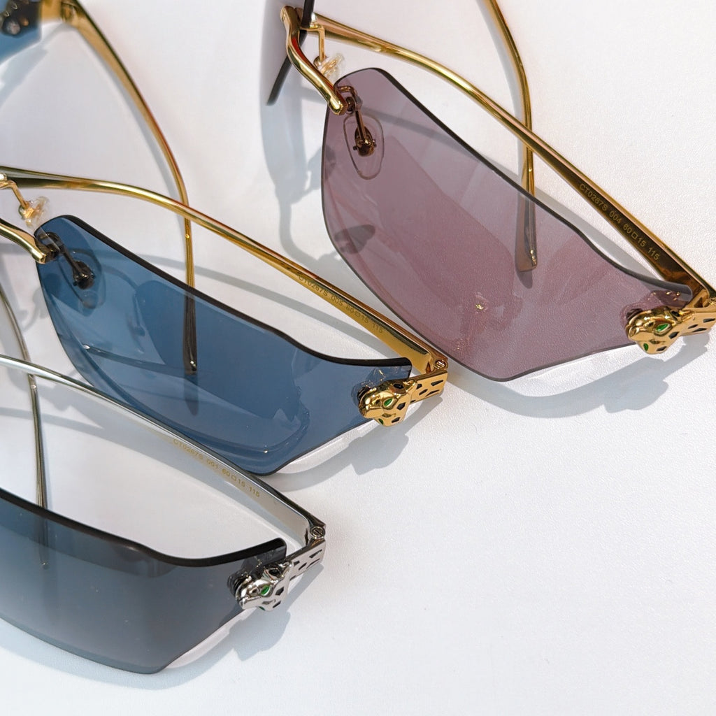 Cartier sunglasses close-up pair: pink and blue-tinted lenses with gold frames