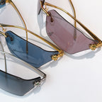 Cartier sunglasses close-up pair: pink and blue-tinted lenses with gold frames