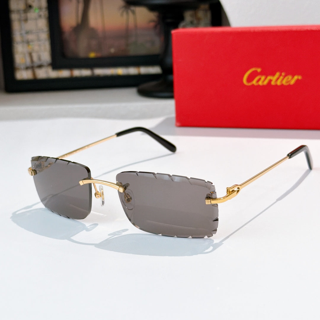 Sunglasses with gray-tinted lenses, gold frame, and black temple tips.