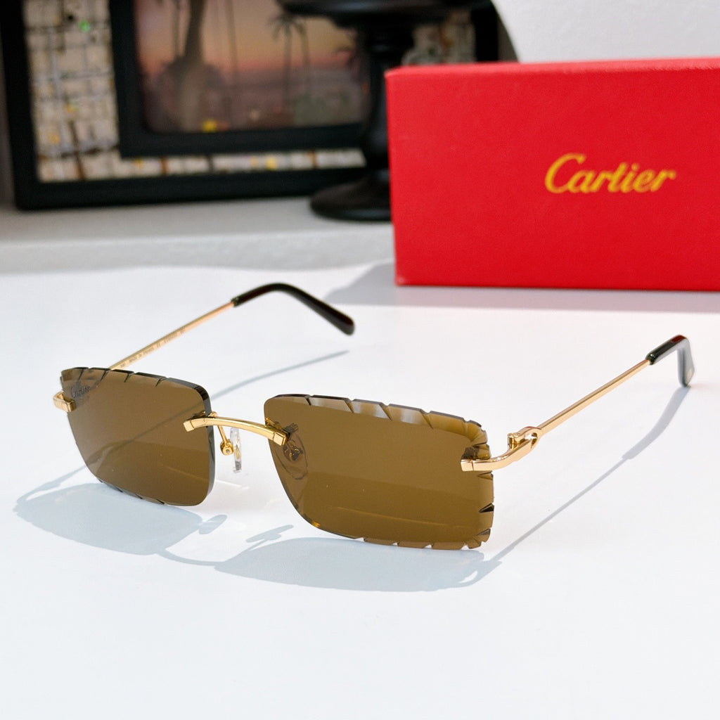 Sunglasses with brown-tinted lenses, gold frame, and black temple tips.
