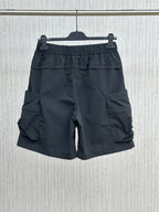 Navy cargo shorts with elastic waist, layered front, and side flap pockets