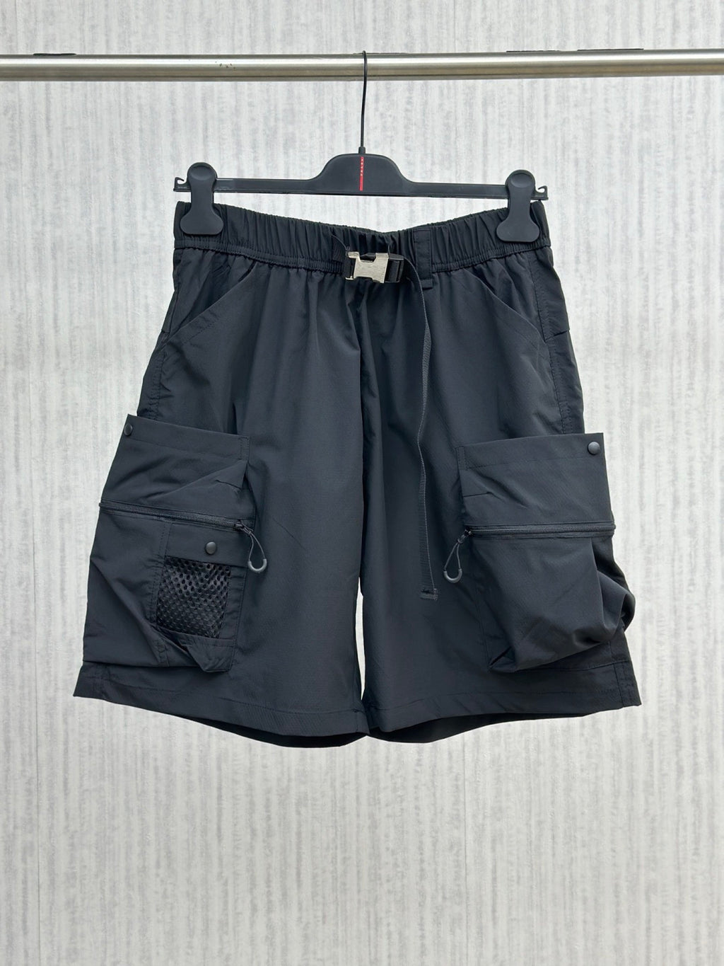 Navy cargo shorts with elastic waistband, drawstring, side and flap pockets