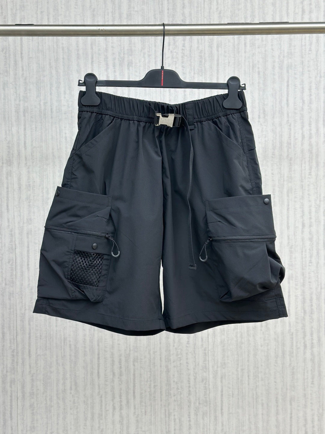 Navy cargo shorts with elastic waistband, drawstring, side and flap pockets