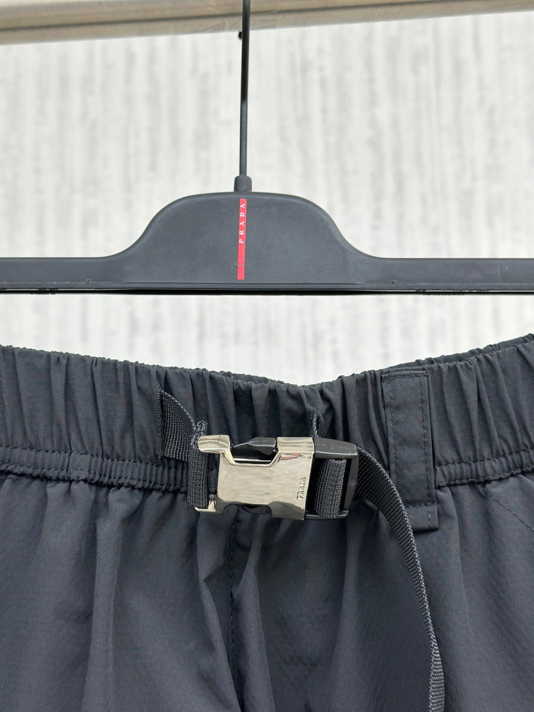 Navy elastic-waist cargo shorts with adjustable buckle waist strap