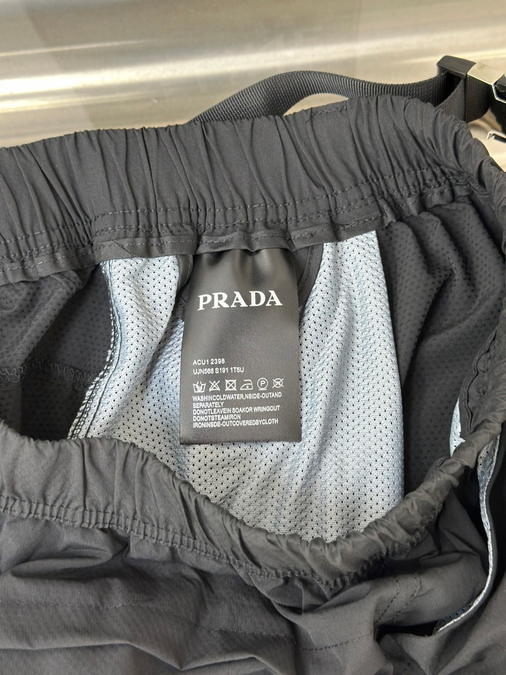 Prada care label inside cargo shorts lining with elastic waistband
