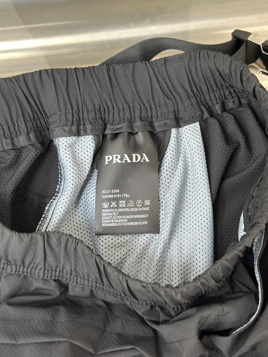 Prada care label inside cargo shorts lining with elastic waistband