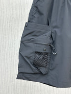 Navy cargo shorts with zippered utility pocket and mesh-lined side pocket