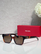 Prada tortoiseshell rectangular sunglasses with brown-tinted lenses and temple branding