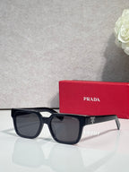 Prada black square sunglasses with dark lenses and temple branding