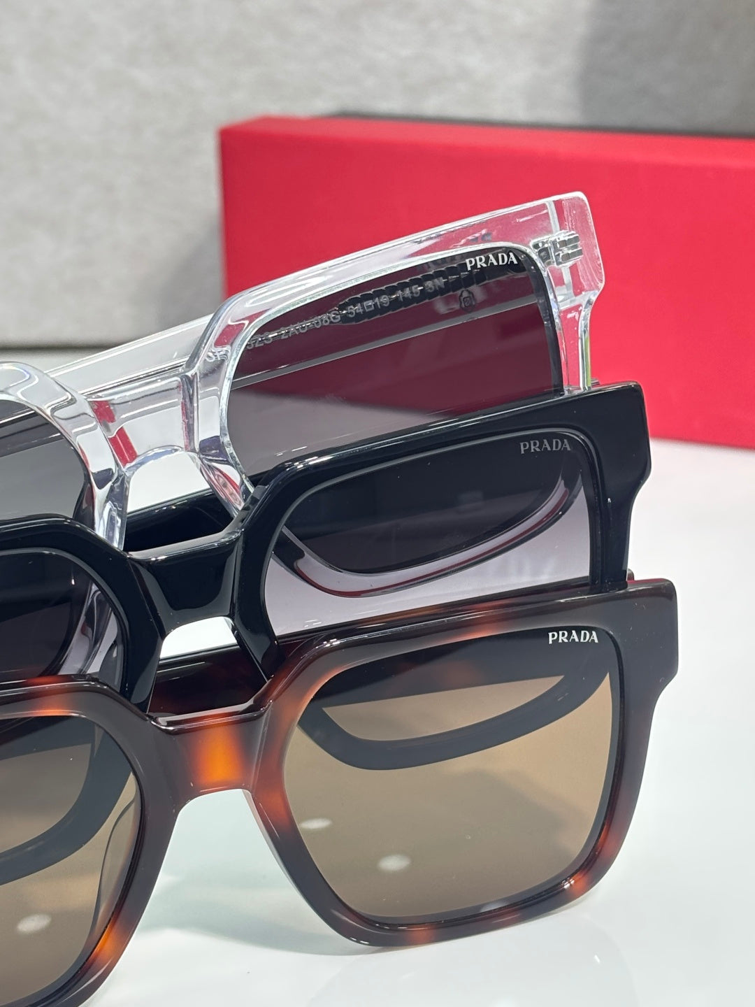 Prada tortoiseshell and black sunglasses close-up with stacked lens frames