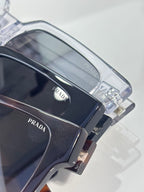 Prada clear and dark sunglasses close-up of the side arm and lens frame