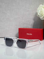 Prada clear-and-silver sunglasses with dark lenses and reflective temple details