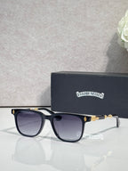 Sunglasses with dark frames and purple-tinted lenses, gold-toned temple accents.
