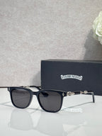 Sunglasses with black frames and dark lenses, metal logo accents on temples.