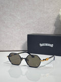 Round sunglasses with black frames, dark lenses, and gold-toned temple details