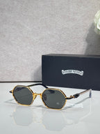 Round sunglasses with gold frames and dark lenses, clear bridge and ornate temples
