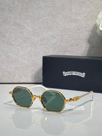 Round sunglasses with gold frames and green-tinted lenses, ornate temple detailing