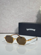Round sunglasses with gold frames and brown-tinted lenses, ornate temple detailing