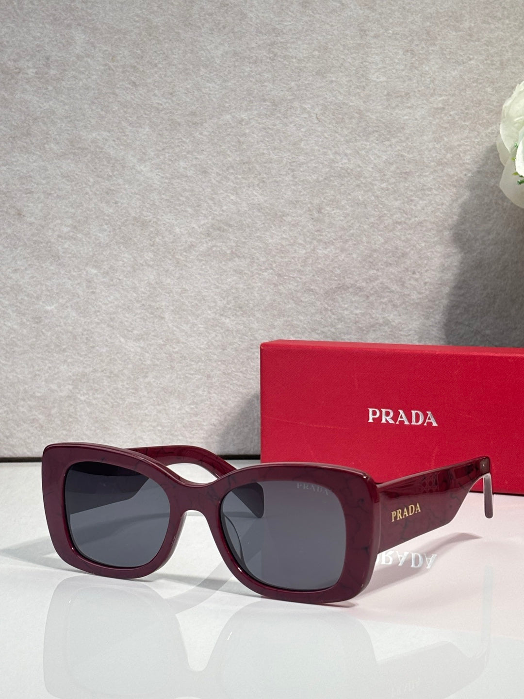 Prada square sunglasses with dark lenses and burgundy frame