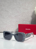 Prada square sunglasses with dark lenses and gray-blue frame