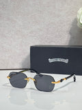 Chrome glasses with dark lenses, gold details, and black temple arms on display