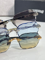 Chrome glasses close-up: blue-tinted lenses with silver frames and gold temple accents