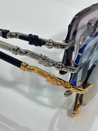 Chrome glasses close-up: transparent lenses with black and gold temple hardware