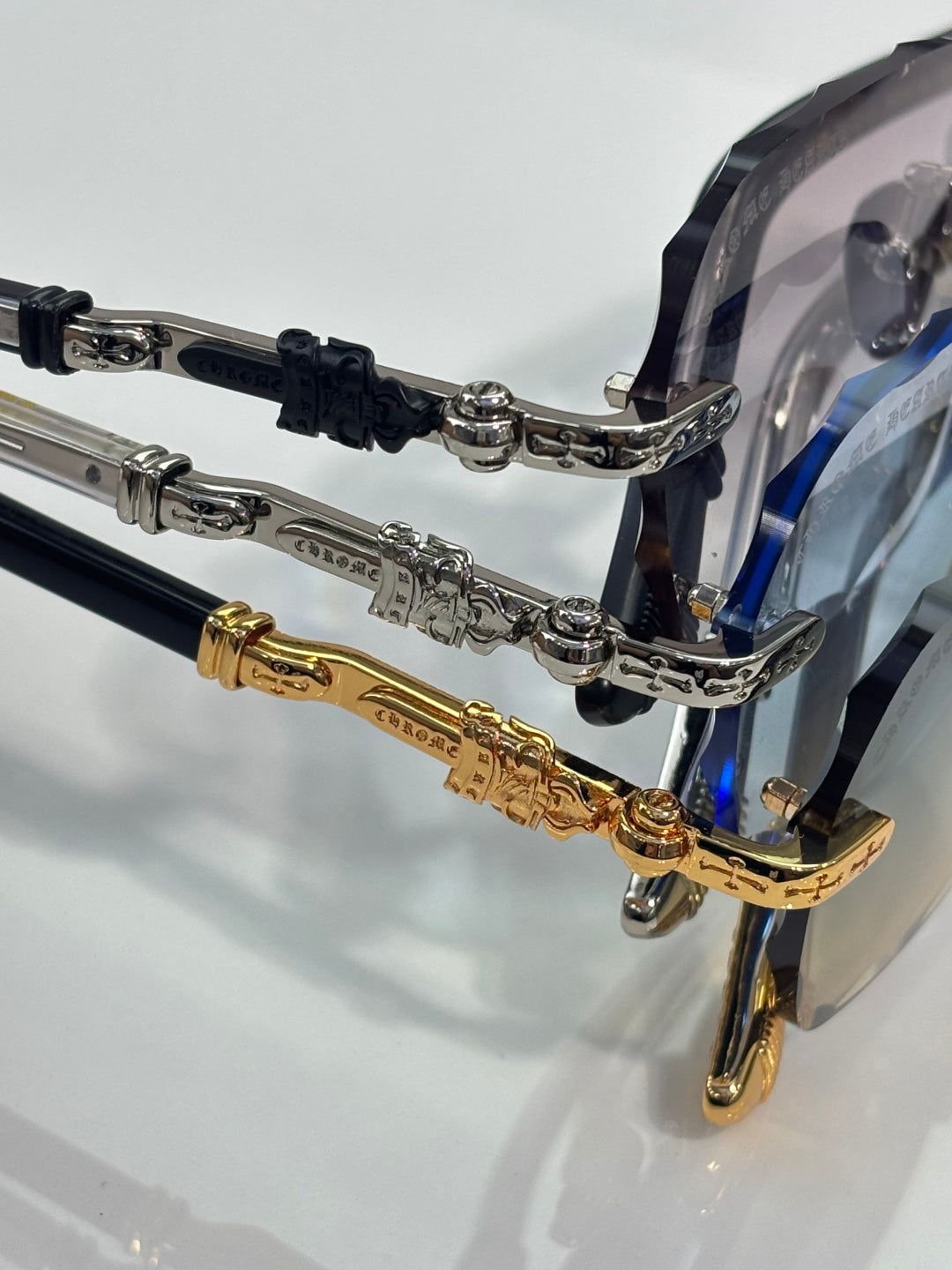 Chrome glasses close-up: transparent lenses with black and gold temple hardware