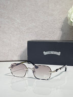 Chrome glasses with clear-to-gray lenses, gold accents, and patterned temple arms