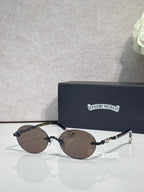 Round eyeglasses with dark lenses and silver-tone frame, with case behind