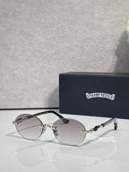 Round eyeglasses with silver-tone frame and dark lenses, shown with case behind