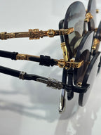 Side view close-up of eyeglass frames with gold detailing and dark temples