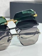 Chrome glasses with green-tinted lenses and black frame, gold arms and hinge detail