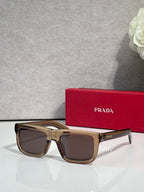 Prada sunglasses with tortoiseshell square frame and dark lenses, logo on arms.